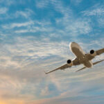 Airplane flying over tropical sea at sunset - Antalya, Turkey
